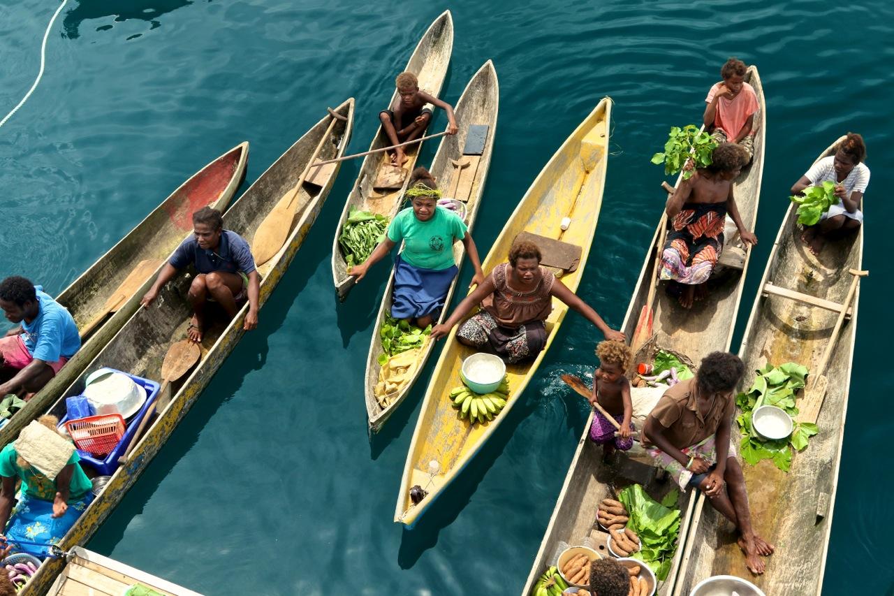 Villagers often paddled out to meet our boat. © Wayne Sentman