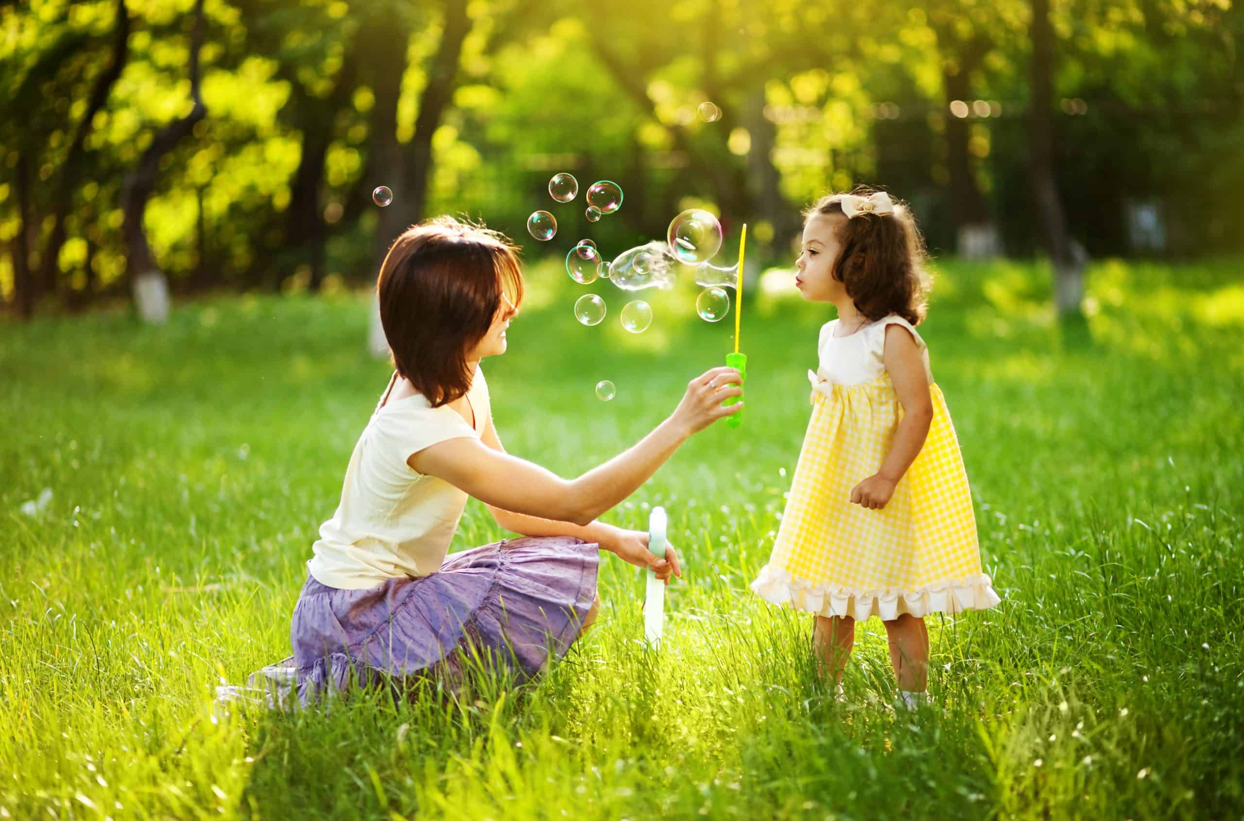 girl blowing bubbles