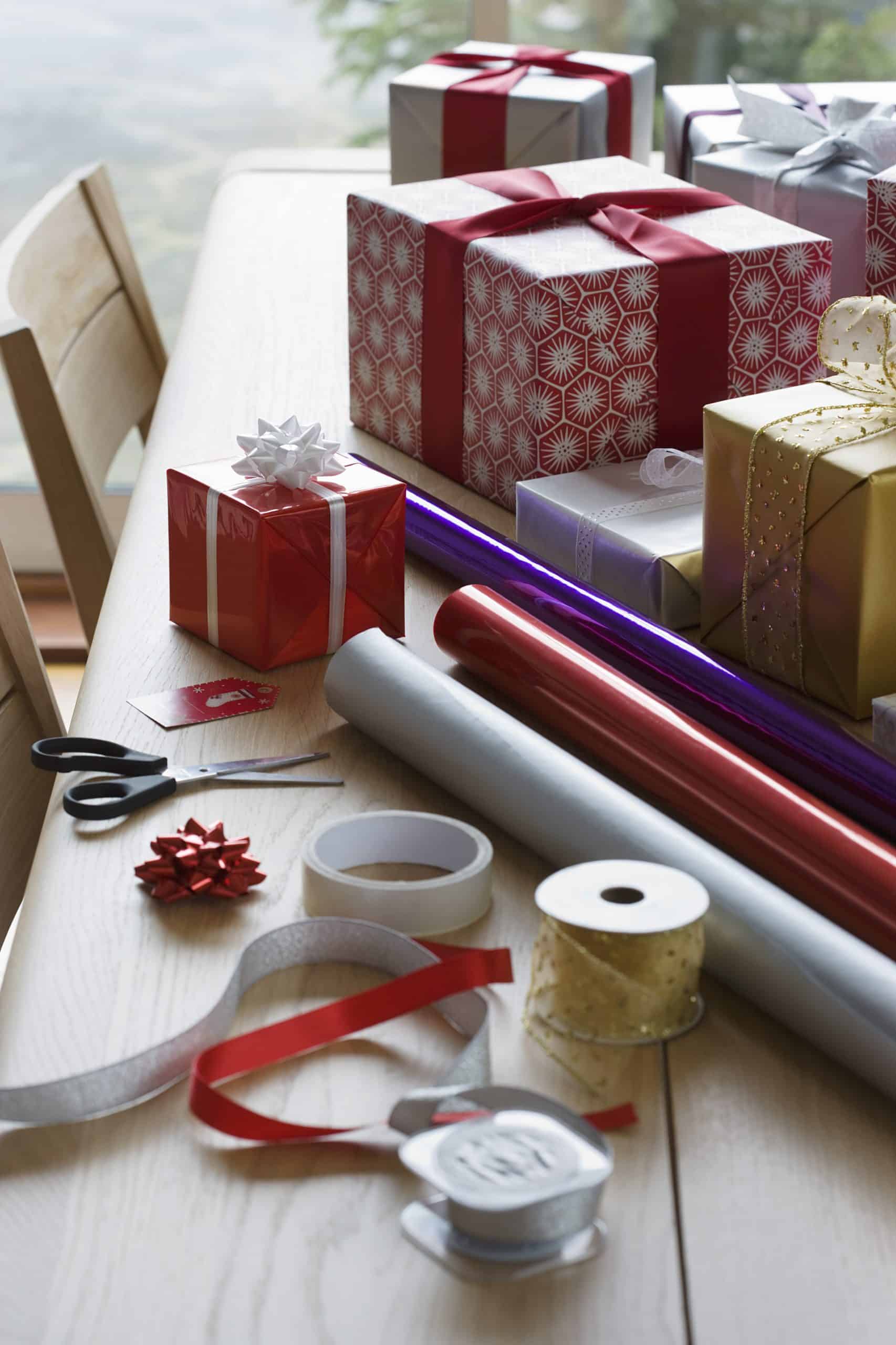 christmas wrapping paper and ribbons on table