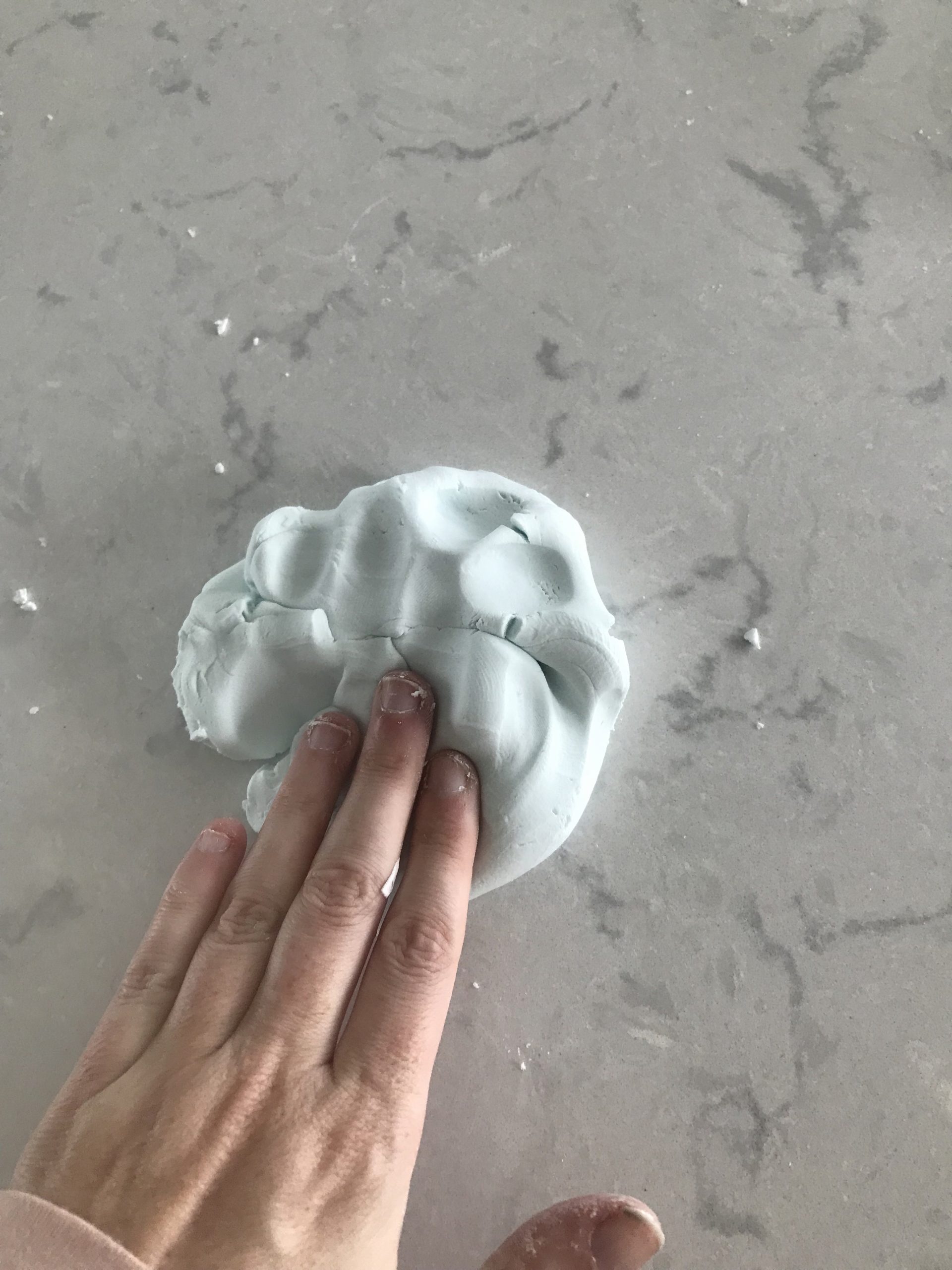 pushing cloud dough with fingers