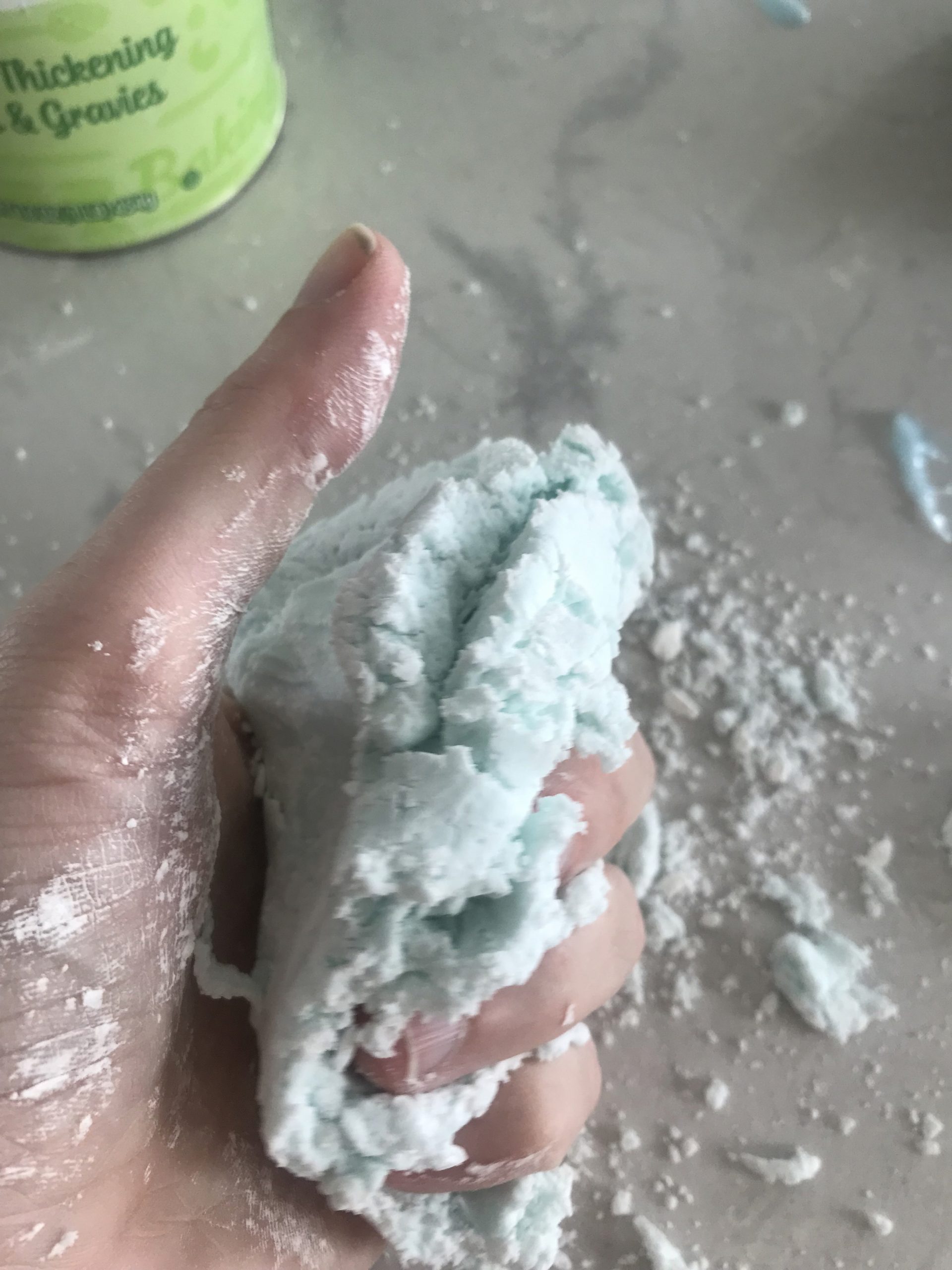 squishing cloud dough in fingers