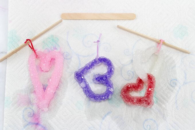 still wet crystal hearts drying on a paper towel after forming in jars