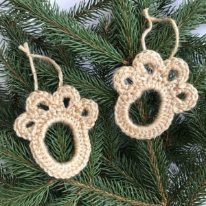 2 crochet paw print ornaments displayed flat