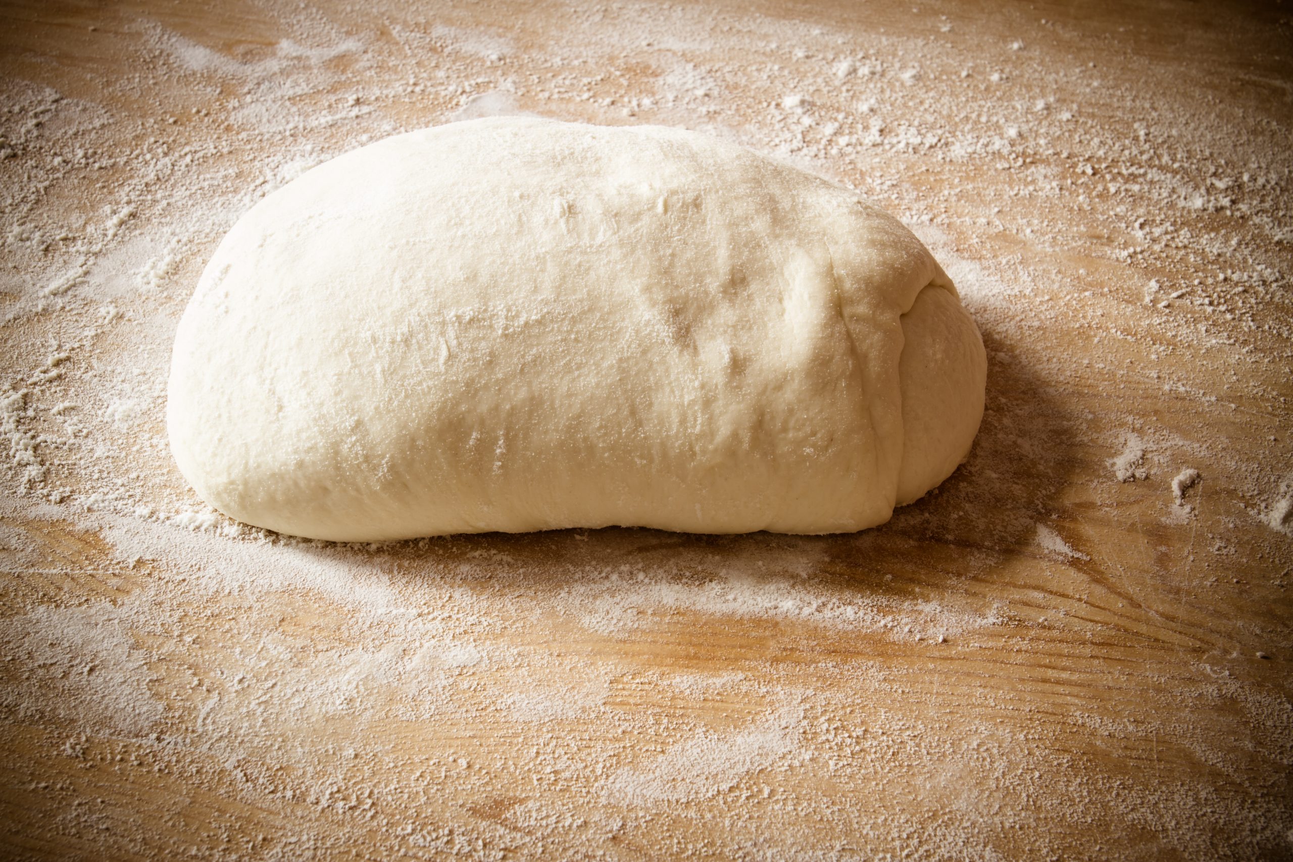 pizza dough on floured surface