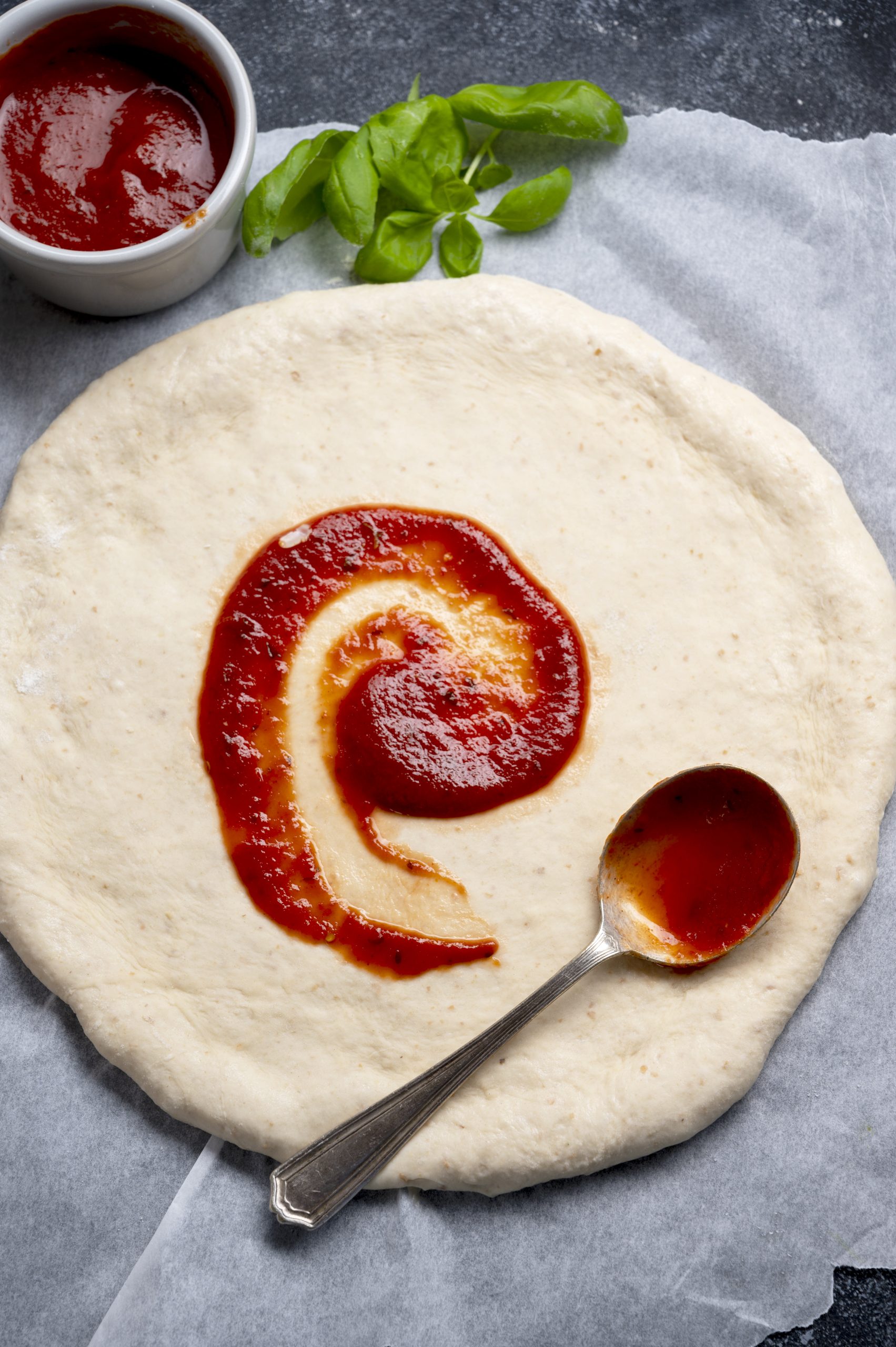 pizza sauce on pizza dough